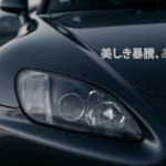 ミッドナイトブルーを基調としたS2000のクローズアップ。文字「美しき暴騰、あるいはバグ。」の下には、ノイズがなく、一筋だけデジタルエラーが走るアイキャッチ